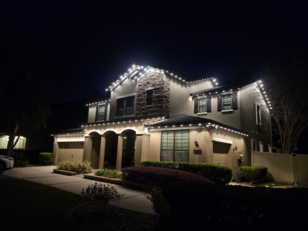 Home with warm white roofline permanent lighting