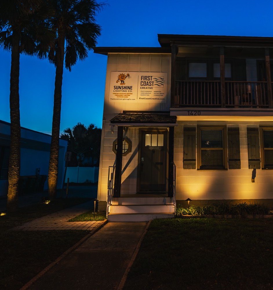 Sunshine Lighting Co. office at dusk with warm architectural uplighting