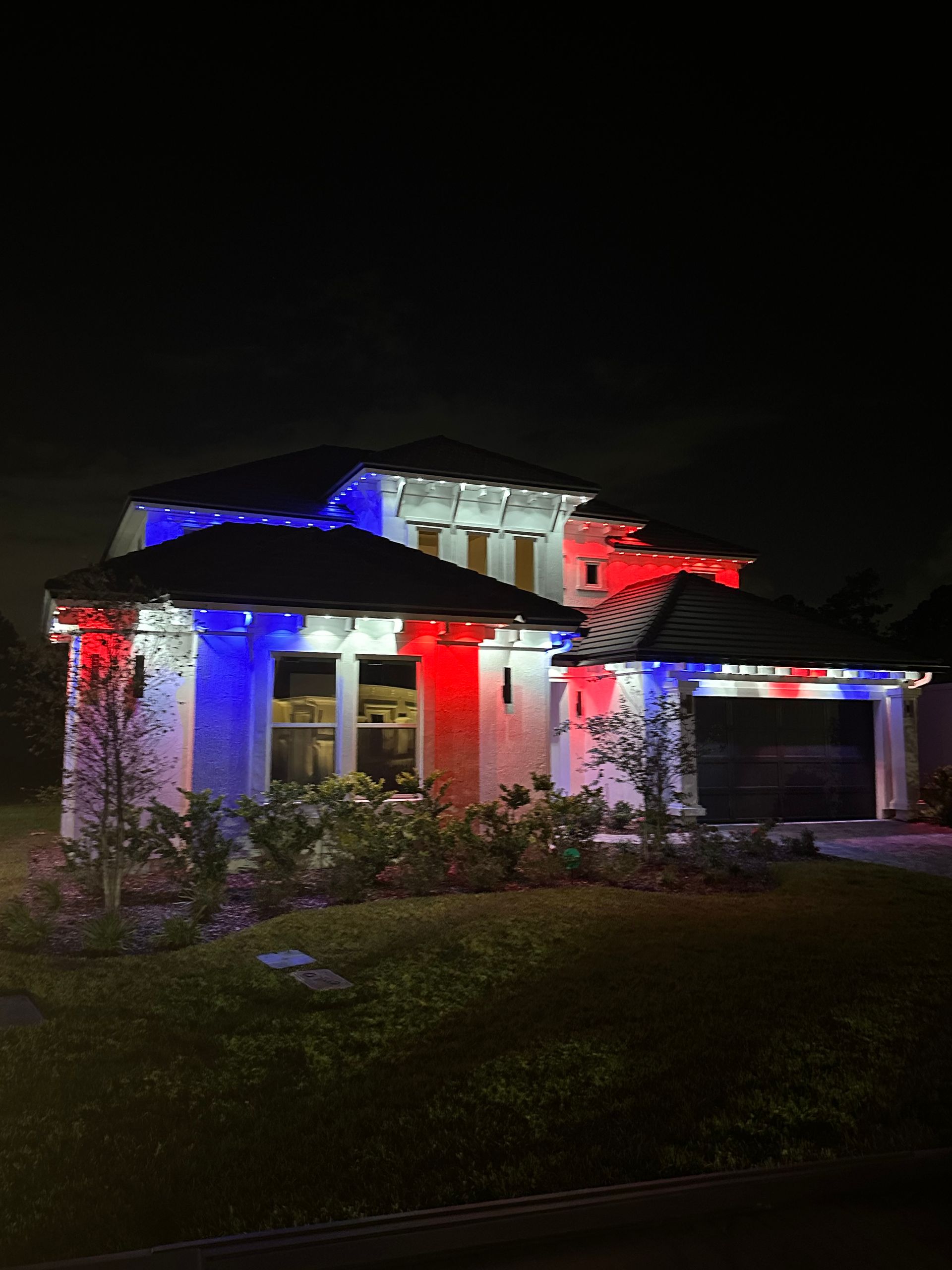 Home with red, white, and blue color-changing permanent lighting